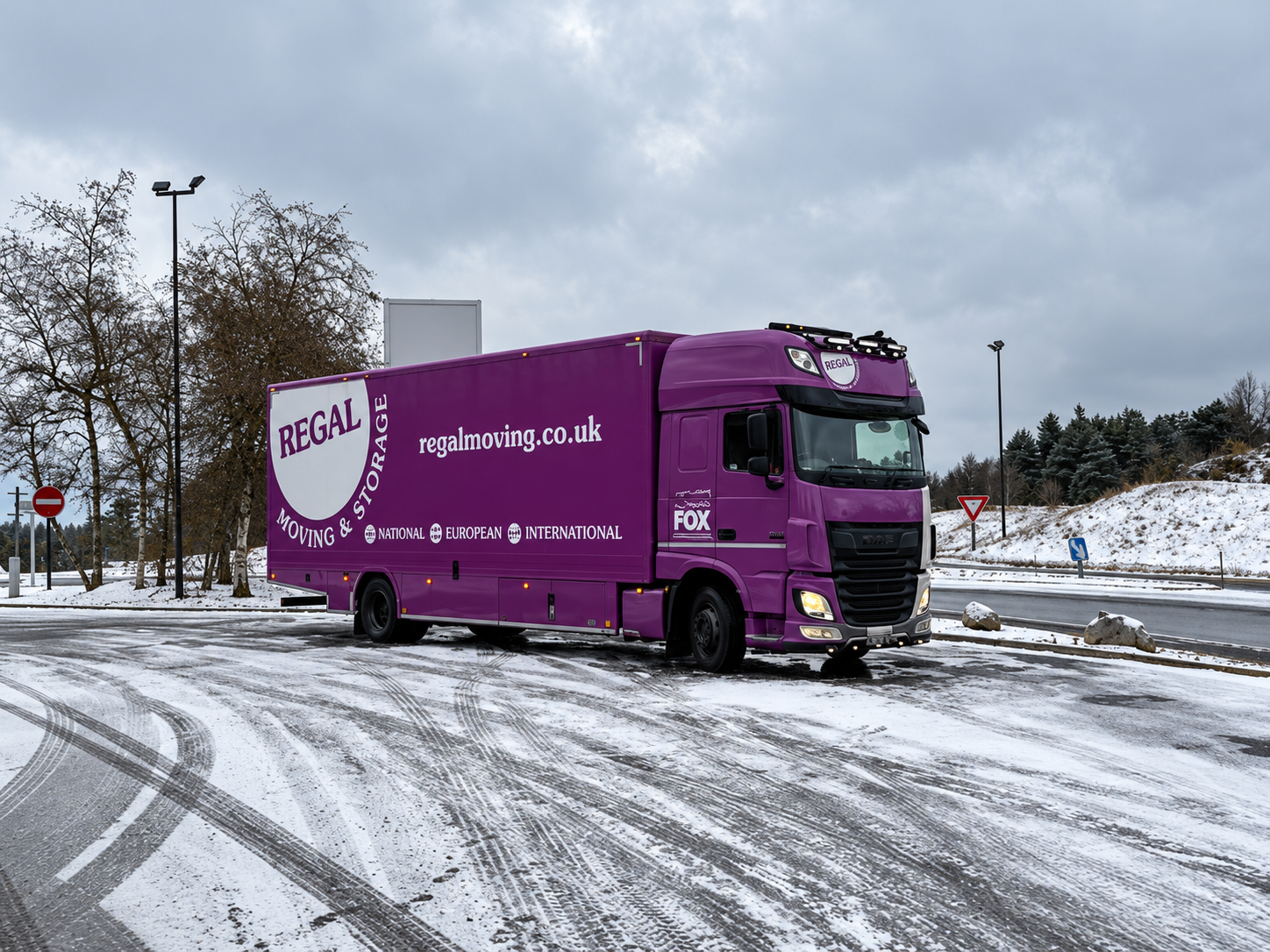 Regal Moving & Storage removal truck on a snow-covered road