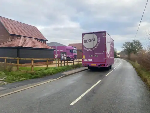 Regal Moving & Storage truck outside a client’s house with the trailer parked at roadside