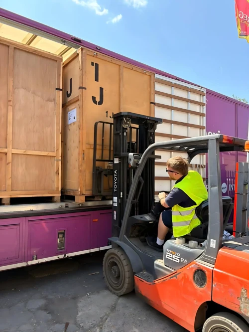 Regal Moving & Storage team member loading a container onto a truck