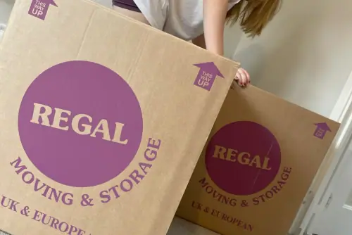 Person using Regal Moving & Storage branded moving boxes