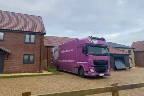 Regal Moving & Storage purple removal truck parked outside a client’s house
