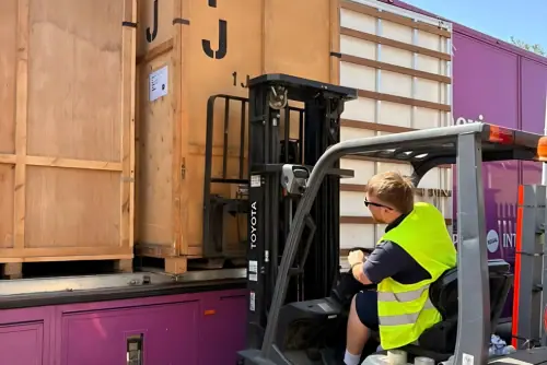 Regal Moving & Storage team member loading a container onto a truck