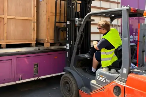 Regal Moving & Storage team member loading a container onto a truck